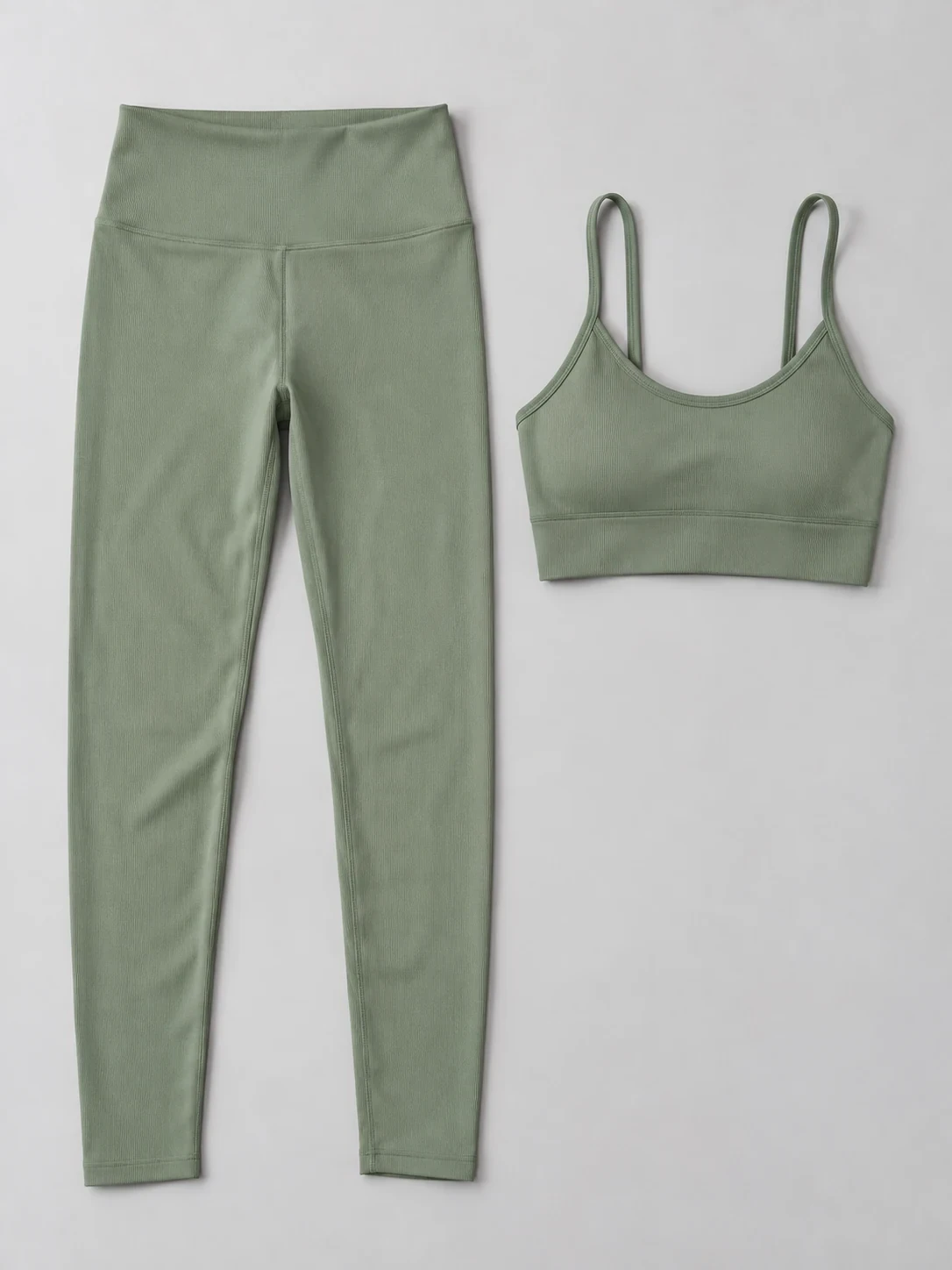 Flat lay of a sage green leggings and sports bra set