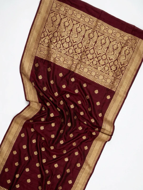 Flat lay of a maroon Banarasi saree